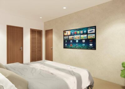 A bedroom with a smart TV mounted on the wall and a plant in the corner.